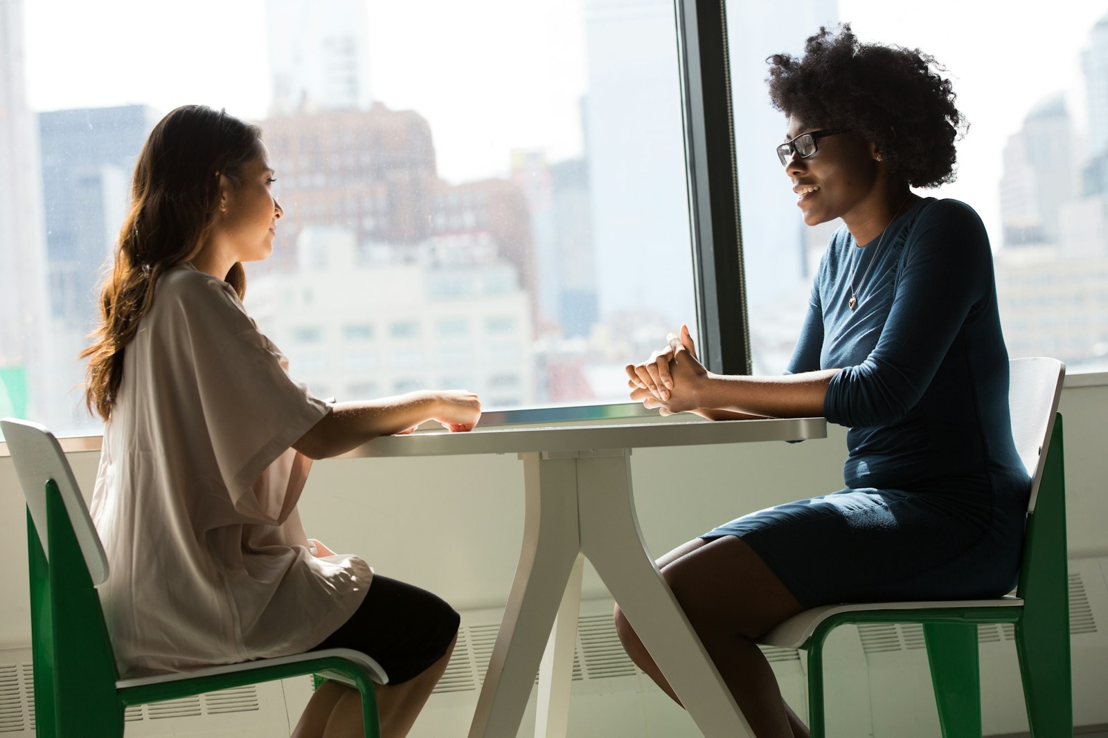 Woman speaking with a coach in a calm room after searching for a life coach near me in South Africa
